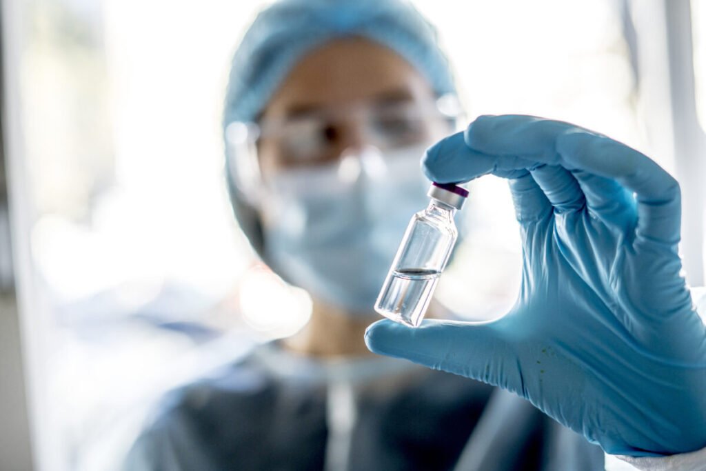Doctor or laborant holding tube with nCoV Coronavirus vaccine for 2019-nCoV virus
